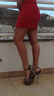 Sexy legs in red dress and heels 
