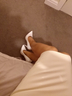 Cream latex, tanned legs, white stilettos 