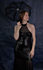 In a form fitting leather-look dress (June 2021)